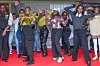 A group of fans, dressed in vibrant performance-ready outfits, poses joyfully at the Nairobi Comic-Convention.