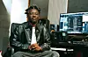 Nigerian producer DeeYasso, photographed in his studio in front of his production desk.