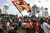 ​A supporter of Ugandan musician turned politician Bobi Wine, waves Ugandan flag during his presidential rally in Fort Portal on November 23, 2020.