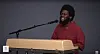 Michael Kiwanuka playing a keyboard and singing into a microphone