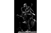 A black and white photo of Joshua Redman playing the saxophone.