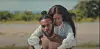 A young couple hold each other in a field in a still scene from Sarkodie's new music video.