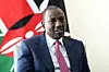 William Ruto in a blue suit with a pink spotted tie.