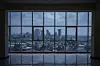 A view of the city's skyline through glass windows.