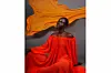 Model in a flowing coral gown with an orange fabric behind her