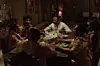 An image from the film The Weekend of people sitting around a table, eating food.