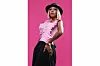 Adelle Onyango wears a stylish pink top, black hat and gold jewelry.