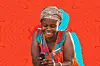 A photo of a woman smiling while looking into her mobile phone.