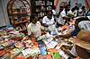 Visitors look at books at a stand during the International Book Fair at the Abidjan exhibition center in the commune of Port-Bouet in Abidjan on May 15, 2024.