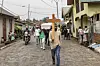A man carries a cross during a funeral procession towards the ITIG Graveyard in Goma on February 4, 2025 where fresh graves have been dug to accomodate victims of the recent violence.