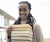 Queer woman holding books