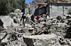 Residents search through the rubble of their homes in Imoulas village of the Taroudant province, one of the most devastated in quake-hit Morocco, on September 11, 2023.