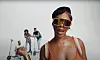 Tiwa Savage poses in the music video for 'You4Me' wearing 90s orange sunglasses and an orange top.