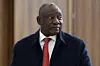 South Africa's President Cyril Ramaphosa wearing a blue wool trench coat, white shirt and a red tie at the BRICS summit in Kazan on October 23, 2024.