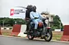 Demonstrators carry a placard as they ride on a motorcycle during the End Bad Governance protest in Abuja on August 1, 2024.