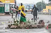 A supporter of the Optimist Party for the Development of Mozambique (PODEMOS) kneels over flowers placed in memory of two slain associates of the party during a strike called in Maputo, on October 21, 2024.