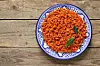 A close up image of a plate of jollof rice on a table.