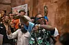 Burna Boy dancing at record release party in LA wearing Frankenstein shirt.