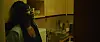 An image from the film of the lead actress leaning against a cupboard