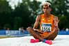Track and field athlete Yaseen Abdalla calming himself after a run, wearing an orange running kit that reads Tennessee.