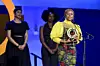 A photo of Citizen Award Recipient Lydia Charles Moyo speaking onstage (with Payzee Mahmod and Danai Gurira standing behind her) during the Global Citizen Prize event at Spring Studios on May 01, 2024 in New York City.