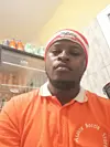 A selfie photo of Alfred Niyonkuru wearing an orange t-shirt.