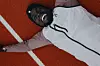 A photo of Dominic Lobalu lying on the track and laughing.