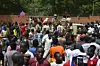 Protesters cheer Nigerien troops as they gather in front of the French Embassy in Niamey during a demonstration that followed a rally in support of Niger's junta in Niamey on July 30, 2023. Thousands of people demonstrated in front of the French embassy in Niamey on Sunday, before being dispersed by tear gas, during a rally in support of the military putschists who overthrew the elected president Mohamed Bazoum in Niger. Before the tear-gas canisters were fired, a few soldiers stood in front of the embassy to calm the demonstrators.