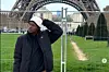 Seyi Oluyole poses in front of the Eiffel Tower