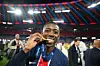 Ousmane Dembele of Paris Saint-Germain bites his Winners Medal after his team's victory to secure Paris Saint-Germain's first ever UEFA Champions League title in the club's history.