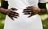 Pregnant African bride in a white dress.