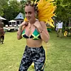 Adele in Jamaican bikini, yellow feathers and Bantu knot hairstyle.