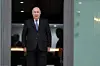 A photo of President Abdelmadjid Tebboune of Algeria wearing a black suit, with a white shirt and a blue tie.