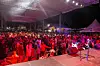 A large audience gathers under a tented stage at the Bob Collymore International Jazz Festival.