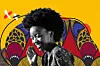 A young Black woman with a natural afro hairstyle smiles brightly, looking slightly down and to the side. She wears large hoop earrings and a patterned dark top. The background is a vibrant digital collage of bold red, yellow, blue, and black African-inspired patterns, set against a bright yellow backdrop. The image combines photography and illustration, giving it an energetic, joyful feel.