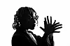 South African artist Yugen Blakrok poses with her hands in a black-and-white promotional photo.