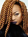 ​Oumou Sangaré profile shot close-up with long braids.