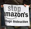 A protestor holds a sign during a rally to halt Amazon's African HQ developments