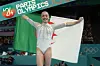 A photo of Kaylia Nemour smiling and holding the Algerian flag after winning the gold medal during the Artistic Gymnastics Women's Uneven Bars Final on day nine of the Olympic Games Paris 2024 at Bercy Arena on August 04, 2024 in Paris, France.