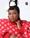 A close up of Yemi Alade in a fluffy red polka dot sweater.