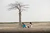 A couple sits under a tree in a scene from DJ Snake\u2019s music video film Patience.
