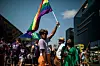 Person waving rainbow flag