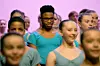 Nigerian dancer Anthony Madu, who won a scholarship after a video of him dancing in Lagos went viral, stands with ballet pupils as they give a performance for Britain's Camilla, Queen Consort during her visit to the Elmhurst Ballet School to celebrate the school's centenary, in Birmingham, on March 14, 2023.
