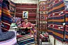 Mohamed Yahya in his shop \u201cYahya Boutique,\u201d surrounded by camel wool carpets made by his father.