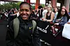 Faith Kipyegon wearing a black track suit and smiling as she arrives for the Athlos NYC at Icahn Stadium on September 26, 2024 in New York City.