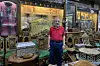 Ebrahim Allam standing in his shop Babany Oriental in front of traditional Egyptian furniture made of wood and mother of pearl.