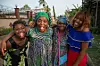 Four African women laughing and sticking their tongues out.