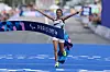 Fatima Ezzahra El Idrissi of Team Morocco celebrates crossing the finish line and taking the Gold Medal during the Women's T12 Marathon on day eleven of the Paris 2024 Summer Paralympic Games on September 08, 2024 in Paris, France.