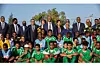 President of the Confederation of African Football (CAF) Patrice Motsepe poses for a photo with students and staff of the national school championship