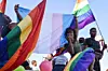 Dozens of people cheer and dance as they take part in the Namibian Lesbians, Gay, Bisexual and Transexual (LGBT) community pride Parade in the streets of the Namibian Capitol on July 29, 2017 in Windhoek.